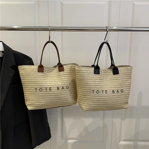 Large straw tote bag with leather handles and TOTE BAG embroidery for beach vacations
