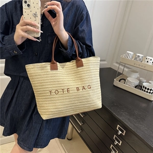 Large summer beach straw tote bag with brown leather handles and embroidered lettering