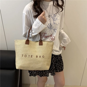 Large capacity woven straw tote bag with brown handles for beach vacation and summer travel