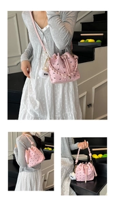 Pink pleated bucket bag with bow texture, braided handle, and plush bear charm