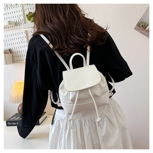 Rear view of a white mini drawstring backpack with mira embossing on soft leather
