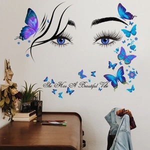 Sticker mural yeux et papillons avec citation She Has A Beautiful Vibe pour décoration