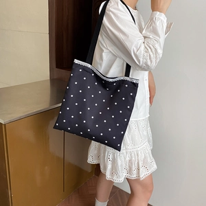 Floral canvas tote bag with delicate white lace trim and minimalist shoulder strap style