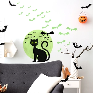 Luminous Halloween wall decal featuring a black cat, full moon, and glowing bats set