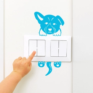 Luminous blue dog light switch wall sticker set applied around white home outlet