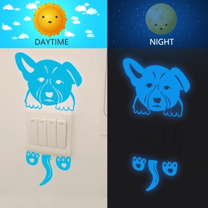Glow-in-the-dark blue puppy light switch sticker showing daytime and night-time fluorescent effect