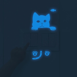 Glow in the dark blue cat wall stickers decorating a light switch in the bedroom