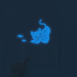 Glow in the dark wall sticker featuring a small kitten and fish for light switch decor