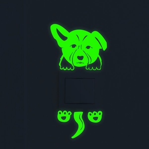 Luminous green corgi wall sticker glowing on a black light switch in a dark room