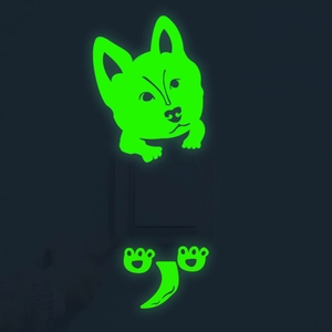Luminous green puppy wall stickers glowing in the dark around a light switch