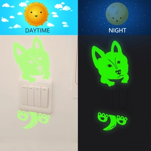 Luminous cartoon dog switch sticker showing glowing green effect in dark vs daytime