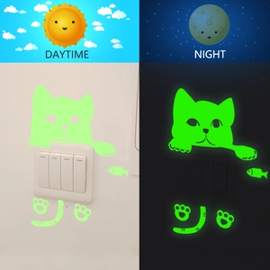 Luminous cat light switch sticker with glow-in-the-dark paw and fish wall decals