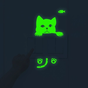 Luminous green glowing kitten wall sticker shown in dark bedroom light switch setting