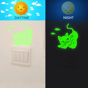 Luminous cat and fish light switch stickers showing daytime and nighttime glow effects