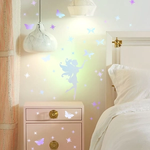 Luminous fairy and butterfly wall stickers in a cozy bedroom with warm ambient lighting