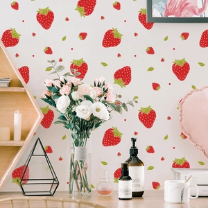 Red strawberry wall stickers in a cozy bedroom setting with minimalist decor