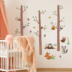 Detail of forest animal wall stickers with deer and owls in a cozy nursery room decor