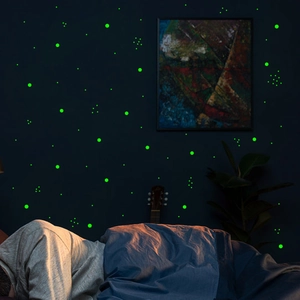 Luminous glow in the dark dot wall stickers showing a starry night effect in a bedroom