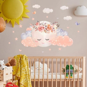 Detailed watercolor wall decals with moon and cloud motifs in a cozy nursery bedroom