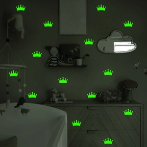 Luminous green crown wall stickers glowing in a dark children's room interior