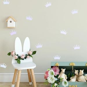 Detailed view of lavender and white crown wall stickers in a cozy child bedroom setting