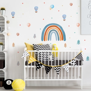 Detailed wall layout of cartoon rainbow and hot air balloon stickers in a cozy nursery
