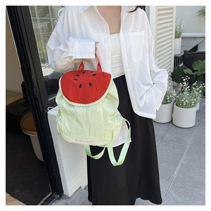 Watermelon shaped canvas backpack with red top flap and embroidered seed details