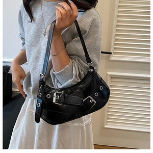 Detail of glossy black moon bag with silver buckles and Y2K punk style hardware