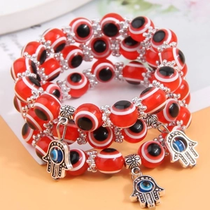Three-layer red evil eye beaded bracelet with silver Hamsa hand charms and resin beads