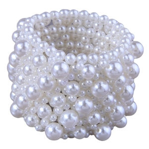 Elastic wide multi-strand pearl bracelet featuring varying sizes of white pearls