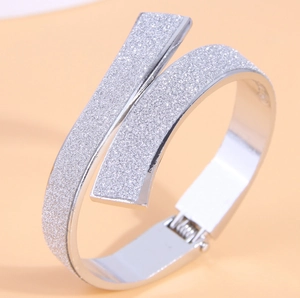 Sleek silver crossover bangle with starry frosted finish and hinged opening