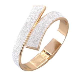 Minimalist gold metal crossover hinged bracelet with parallel silver glitter inlay