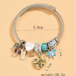 Silver charm bracelet with blue dragonfly, heart pendants and crystal beads on beige base