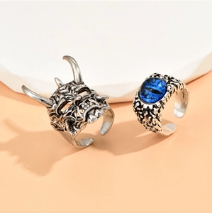 Detail of gothic devil head ring and blue evil eye stone ring for men in retro silver