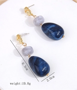 Detailed view of resin drop earrings showing 6.3cm length and 19.8g weight dimensions