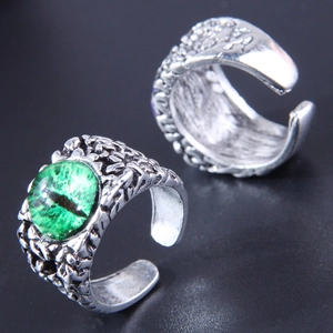 Macro shot of retro silver adjustable evil eye ring with green gemstone and textured band
