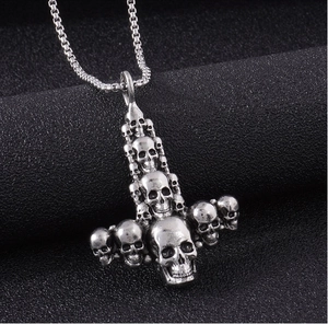 Detailed macro shot of vintage skull Mjolnir pendant with oxidized stainless steel box chain