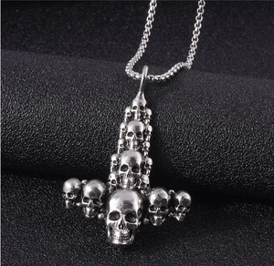 Close-up of gothic skull cross pendant with vintage silver finish on box chain