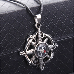 Retro compass pendant necklace with silver starburst design on a black display box