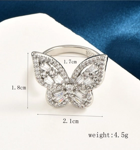 Macro shot of silver butterfly ring with cubic zirconia and dimension labels 1.8x2.1cm