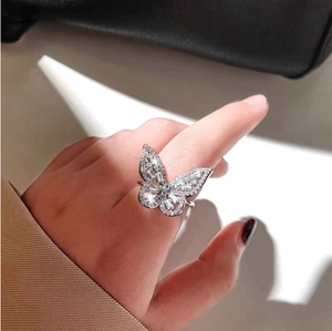 Sparkling copper butterfly open ring featuring cubic zirconia stones on silver finish