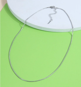 Detailed view of silver snake bone chain with lobster clasp and adjustable extension link