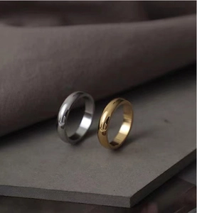 Macro shot of minimalist gold and silver polished stainless steel bands in set