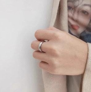 Close-up of a silver polished dome ring in stainless steel worn on a finger