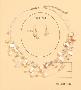 Detailed view of multilayer shell necklace and matching earrings with weight and size info