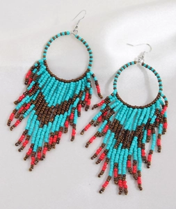 Detail of bohemian hoop earrings with blue, brown, and red handmade beaded tassels