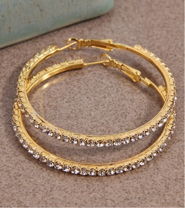 Macro detail of 5cm gold hoop earrings featuring pave set sparkling rhinestones