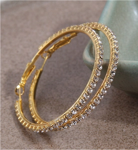 Close-up of 5cm gold hoop earrings with sparkling micro-paved rhinestones for women