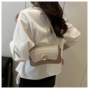 Detail of sequin flap on khaki shoulder bag with gold metal buckle and sleek strap