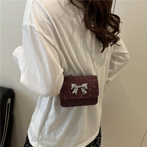 Burgundy snakeskin mini crossbody bag with silver bow buckle and chain strap